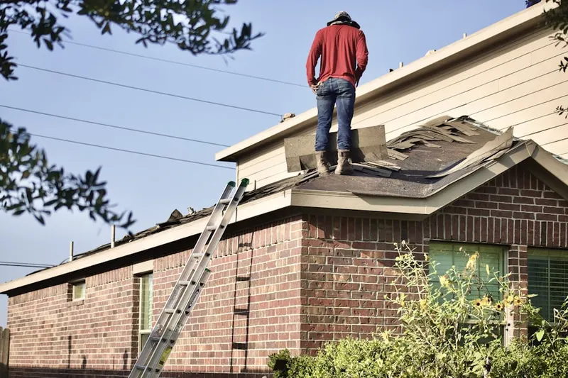 Professional roofer working on a residential roof in Reston